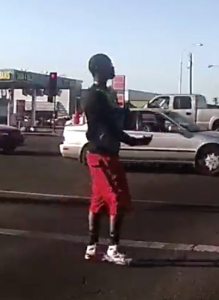 Young man flips off police car